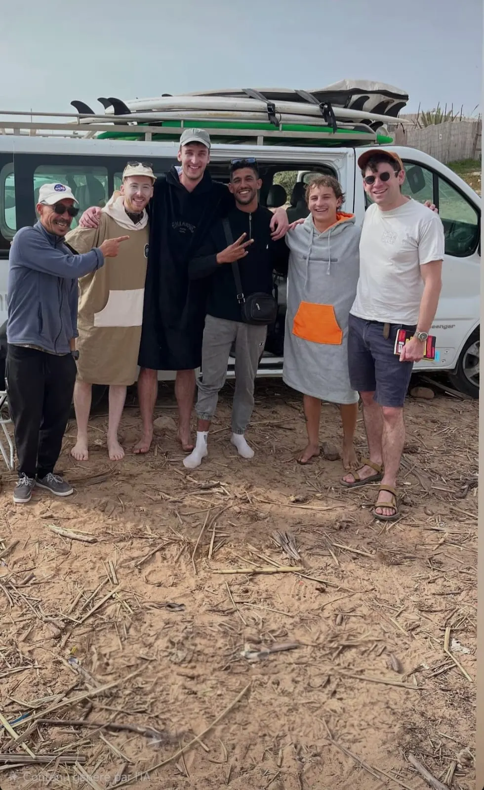 Group of surf guests together beside a board-loaded van
