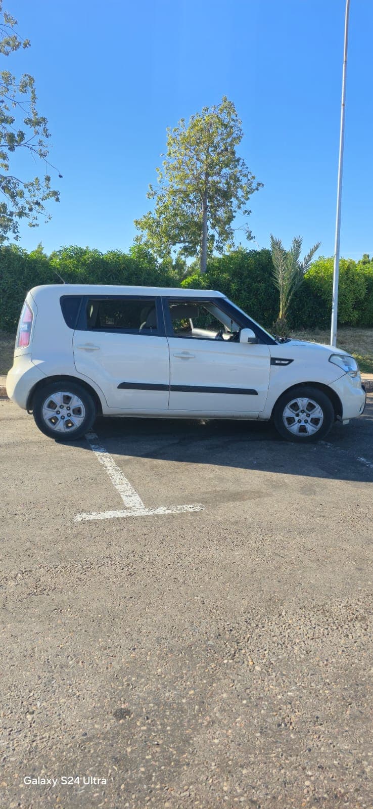White Kia Soul used for local surf transport