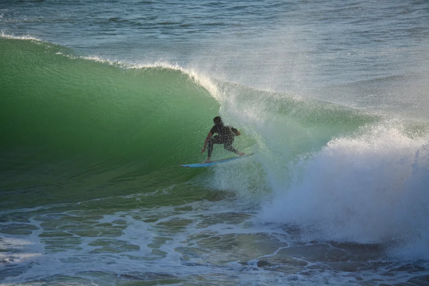 Surfer on a green wave at Panorama Beach Taghazout